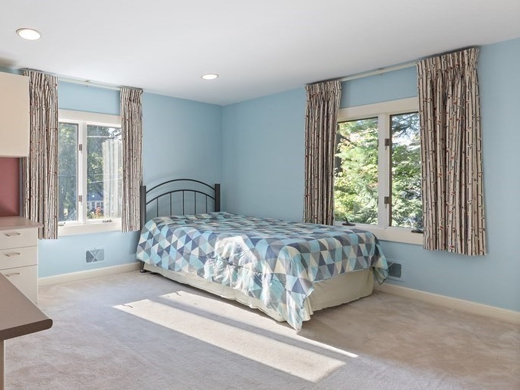 120 Country Club Road Newton, MA 02459 - Photo 11 of 25 a large bed sitting in a room next to a window