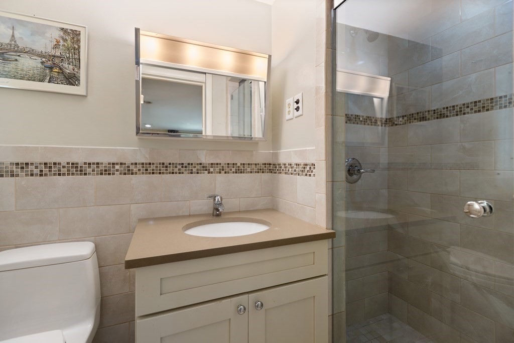 120 Country Club Road Newton, MA 02459 - Photo 16 of 25 a bathroom with a sink toilet and shower
