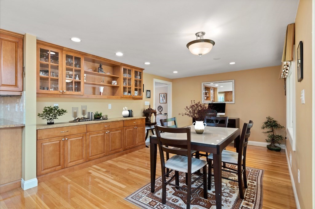 120 Country Club Road Newton, MA 02459 - Photo 6 of 25 a kitchen with stainless steel appliances granite countertop a dining table chairs and white cabinets