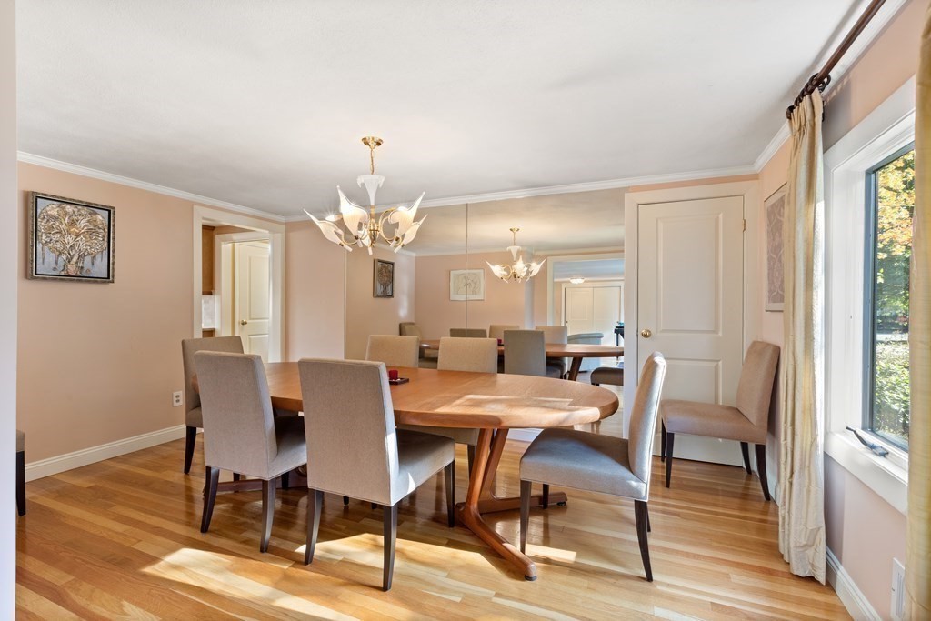 120 Country Club Road Newton, MA 02459 - Photo 9 of 25 a view of a dining room with furniture a chandelier and wooden floor