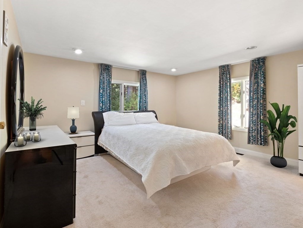 120 Country Club Road Newton, MA 02459 - Photo 10 of 25 a spacious bedroom with a large bed and a potted plant