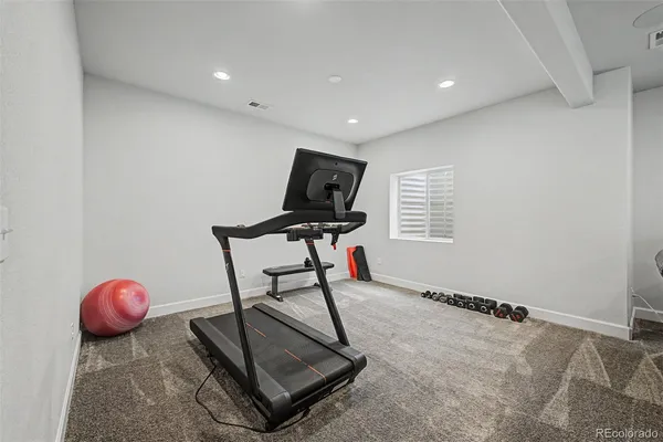a room with gym equipment and a flat screen tv