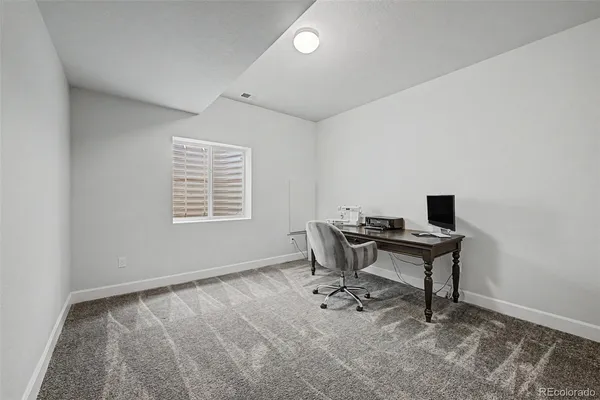 a workspace with furniture and a window