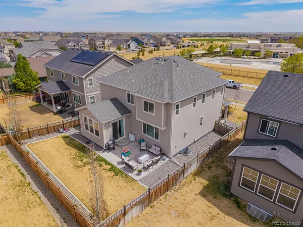 an aerial view of residential houses with outdoor space and ocean view