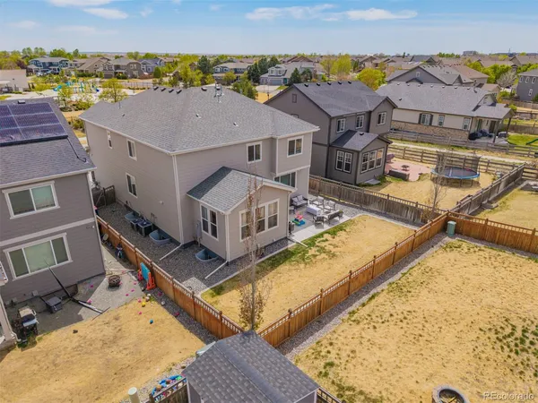 an aerial view of residential houses with yard