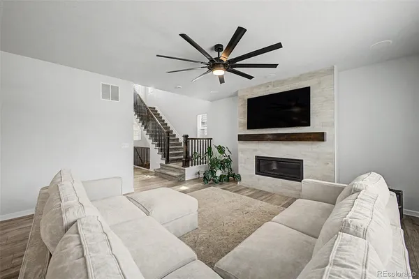 a living room with furniture a fireplace and a flat screen tv