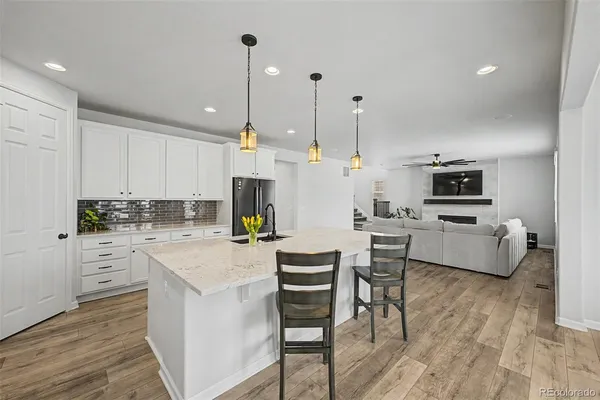 a kitchen with a white cabinets and chairs