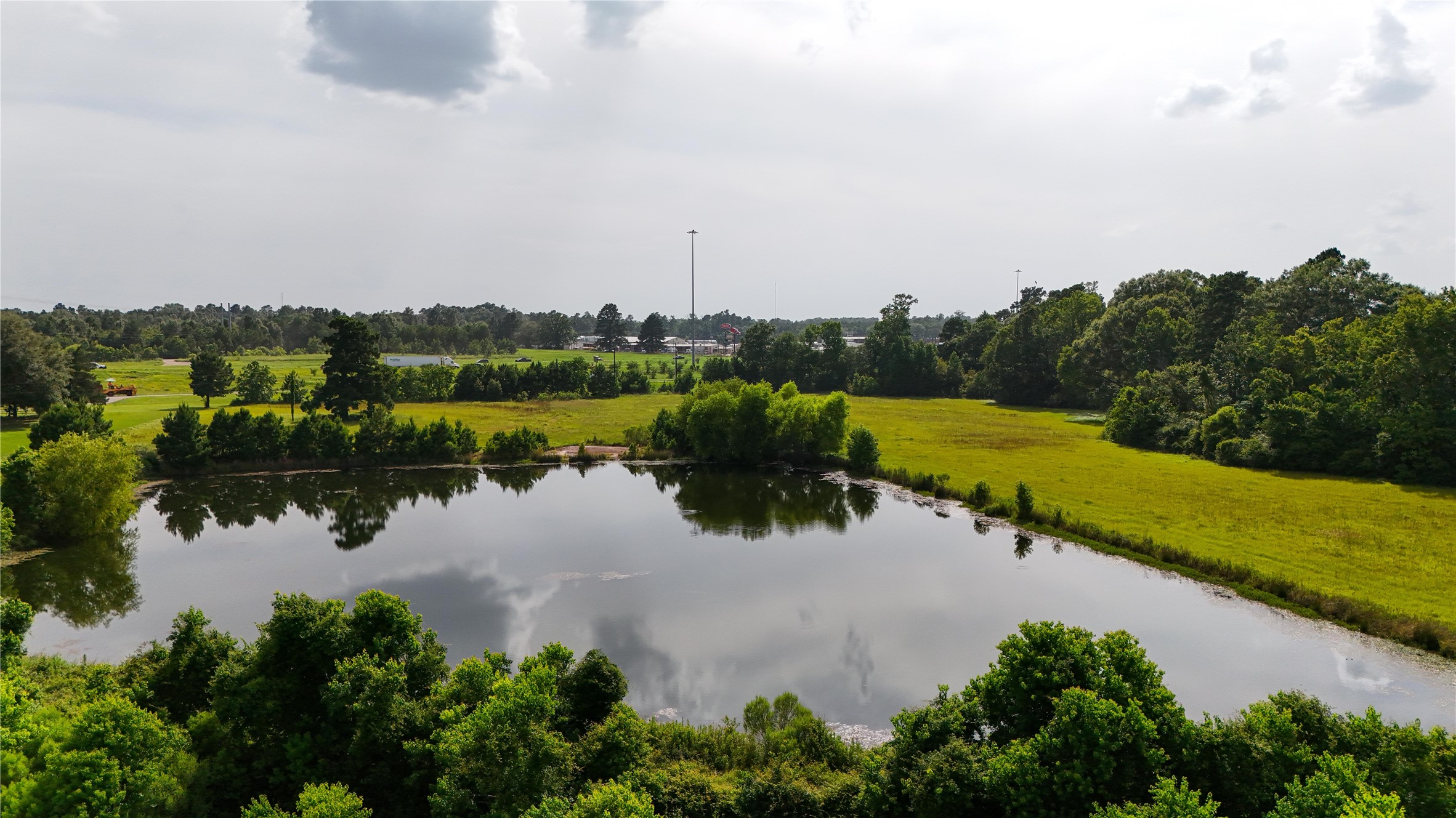 287 Loop 287 Frontage Road Lufkin, TX 75901 - Photo 2 of 22 a view of a lake with houses in the back