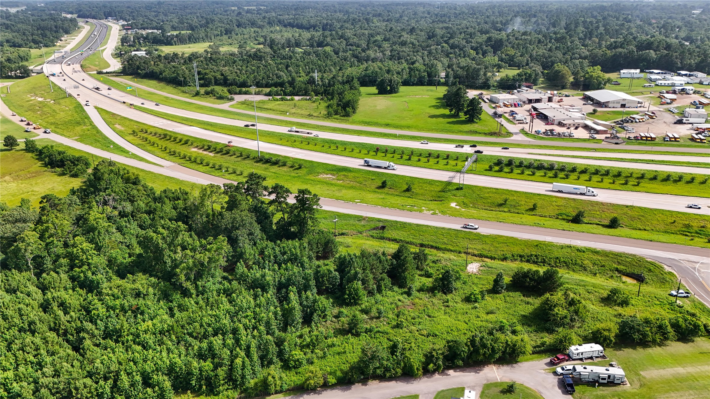 287 Loop 287 Frontage Road Lufkin, TX 75901 - Photo 10 of 22 a view of a swimming pool with a garden and trees