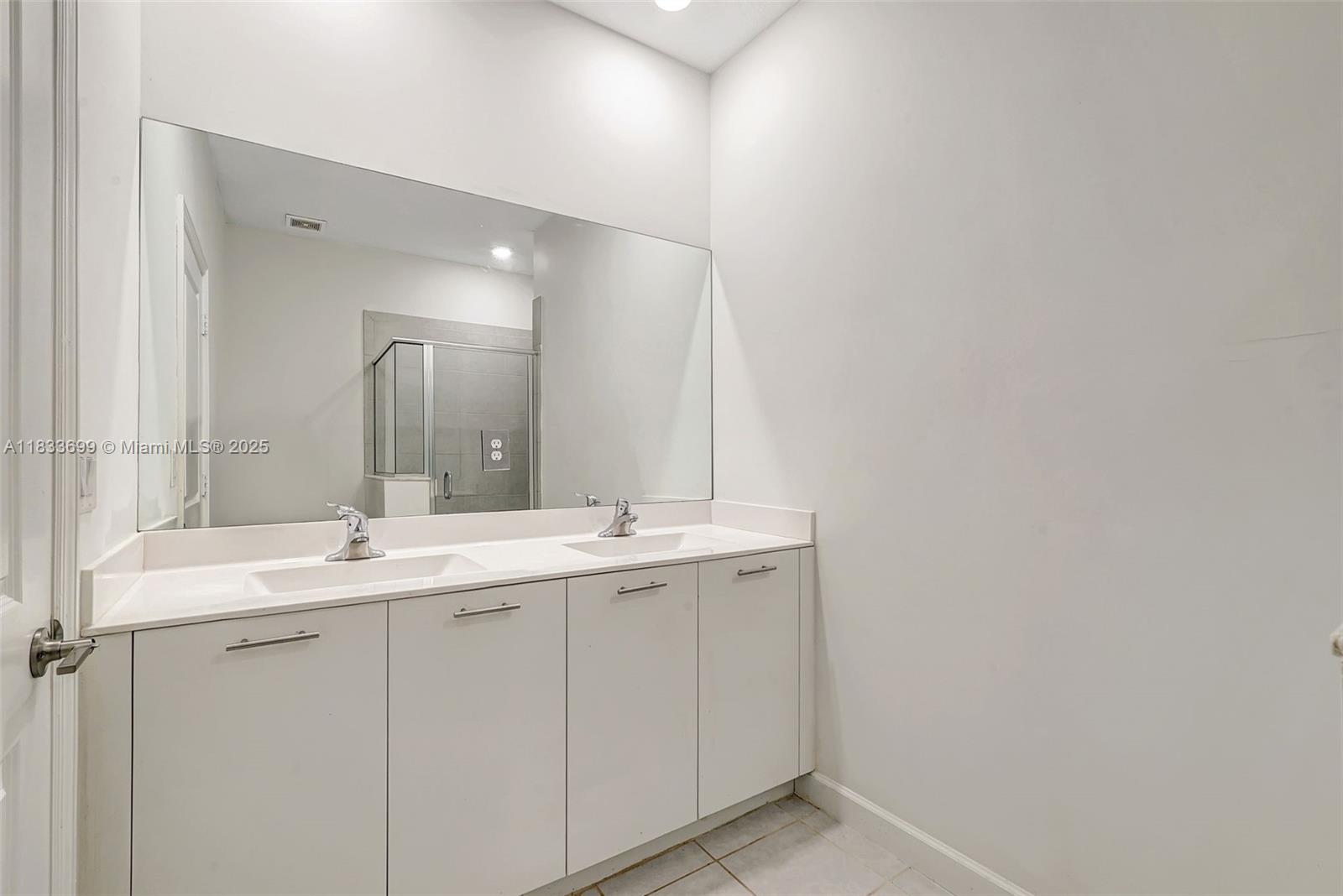 Gladeview Miami, FL 33147 - Photo 39 of 42 a bathroom with a double vanity sink and mirror