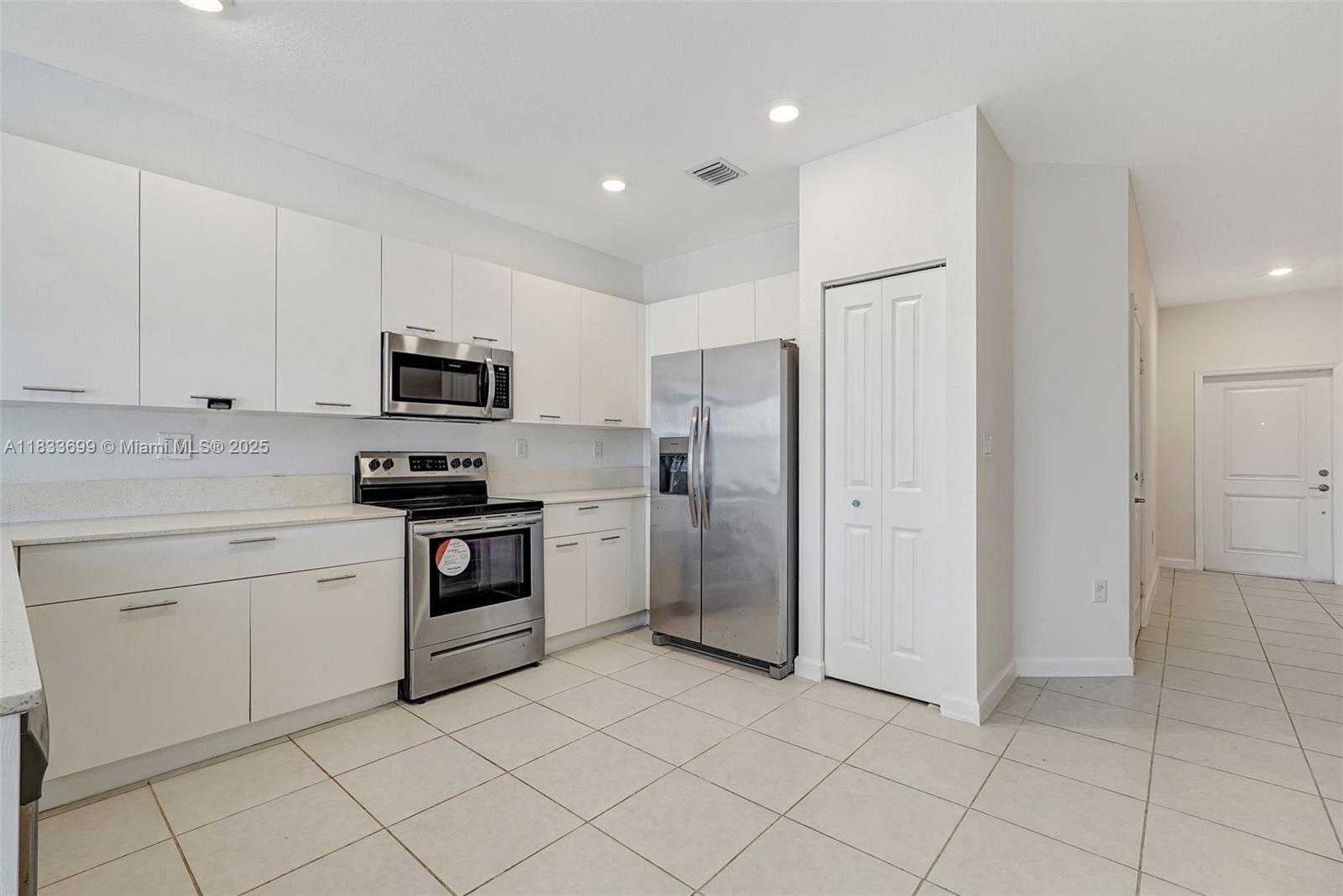 Gladeview Miami, FL 33147 - Photo 8 of 42 a kitchen with white cabinets stainless steel appliances and a sink