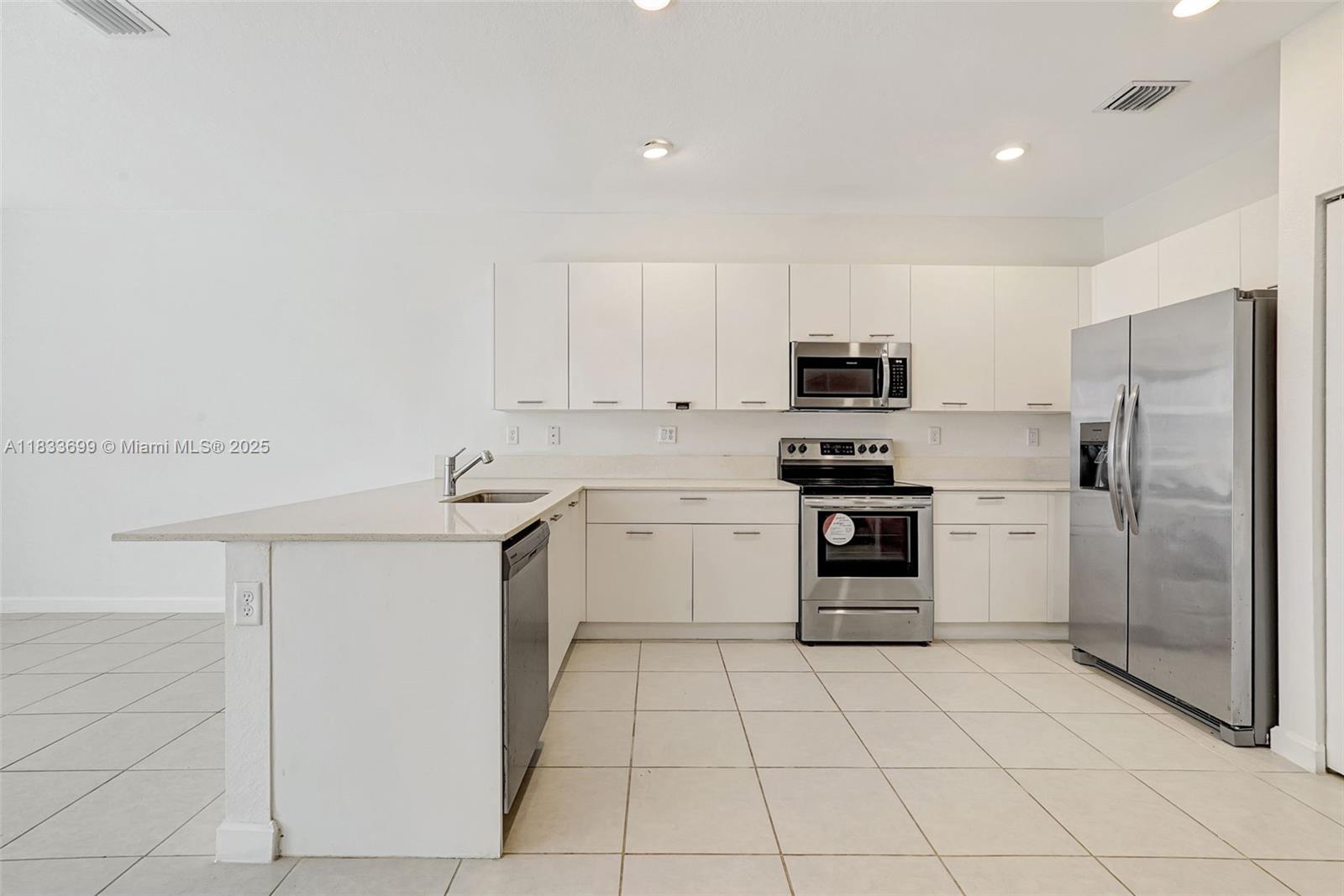 Gladeview Miami, FL 33147 - Photo 9 of 42 a kitchen with granite countertop white cabinets and stainless steel appliances