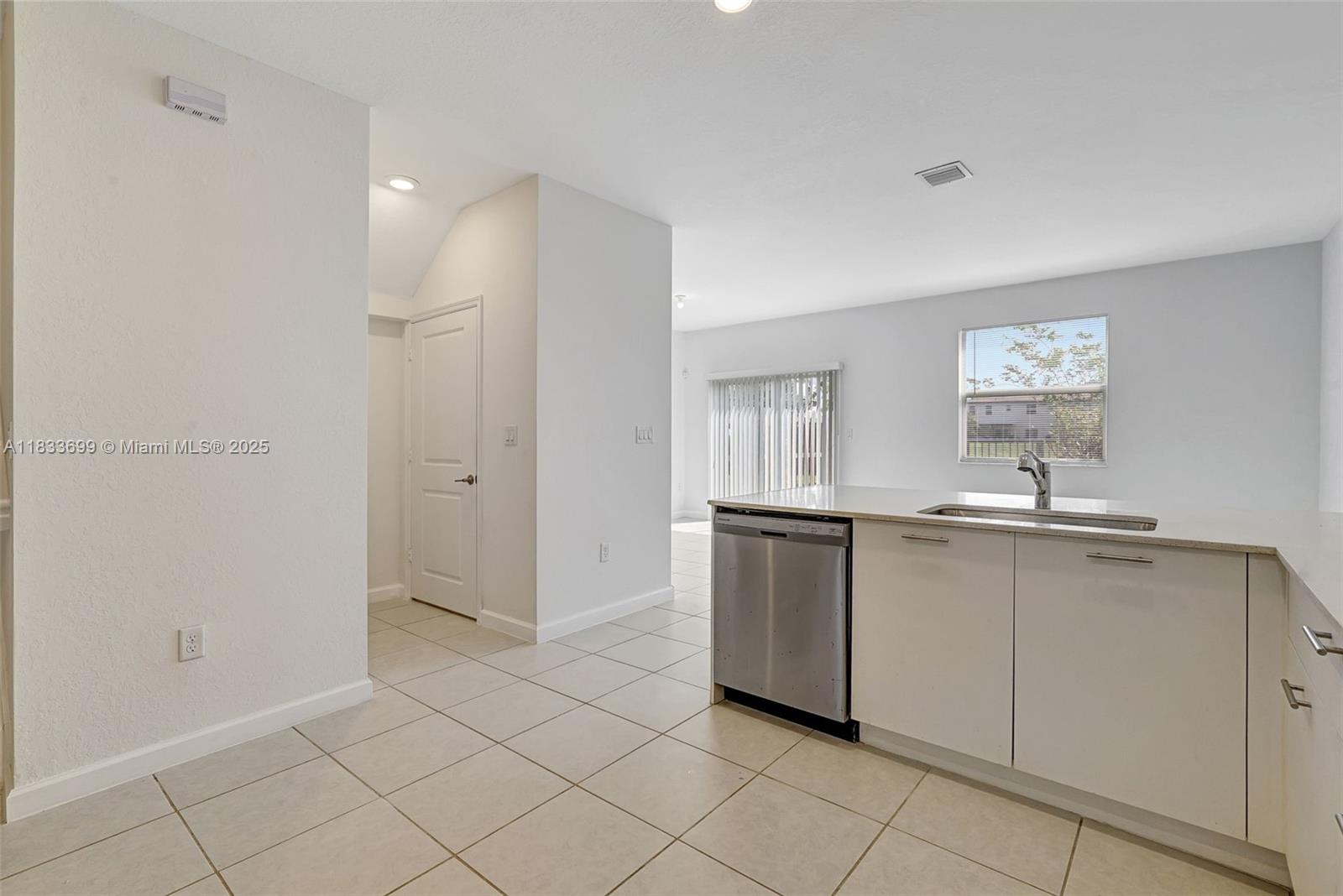 Gladeview Miami, FL 33147 - Photo 10 of 42 a kitchen with white cabinets and sink