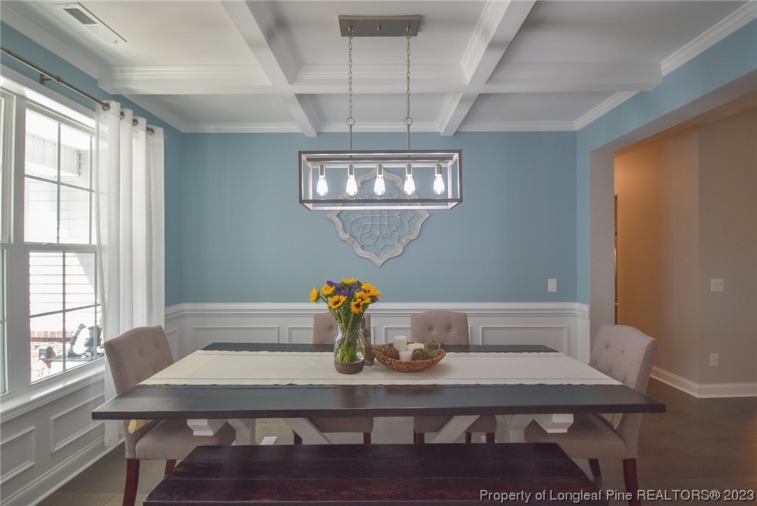 515 Bristling Pine Road Carthage, NC 28327 - Photo 11 of 40 a view of a dining room with furniture a chandelier and wooden floor