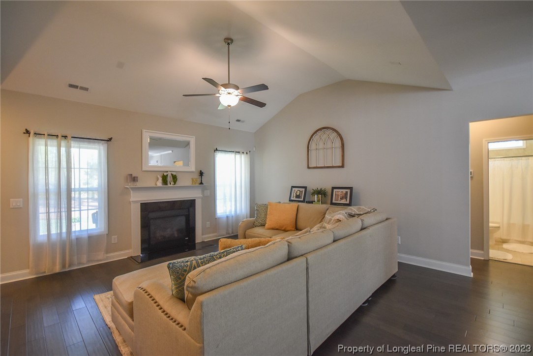 515 Bristling Pine Road Carthage, NC 28327 - Photo 15 of 40 a living room with furniture and a fireplace