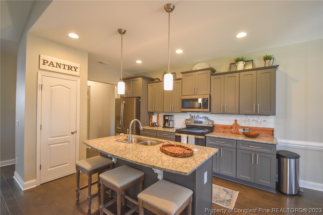 515 Bristling Pine Road Carthage, NC 28327 - Photo 18 of 40 a kitchen with a sink refrigerator and cabinets