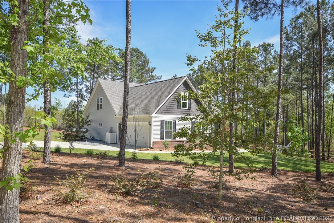 515 Bristling Pine Road Carthage, NC 28327 - Photo 2 of 40 a view of a house with a yard and tree s