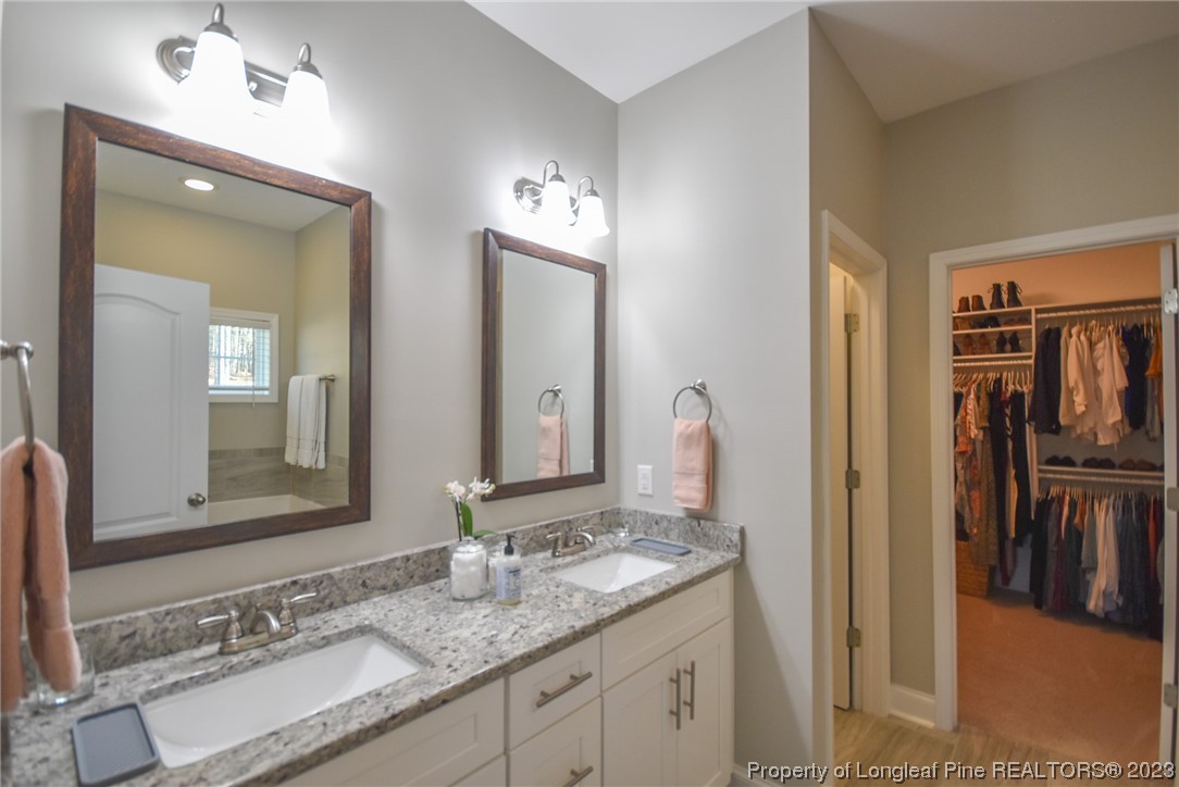 515 Bristling Pine Road Carthage, NC 28327 - Photo 28 of 40 a bathroom with a granite countertop double vanity sink and a mirror