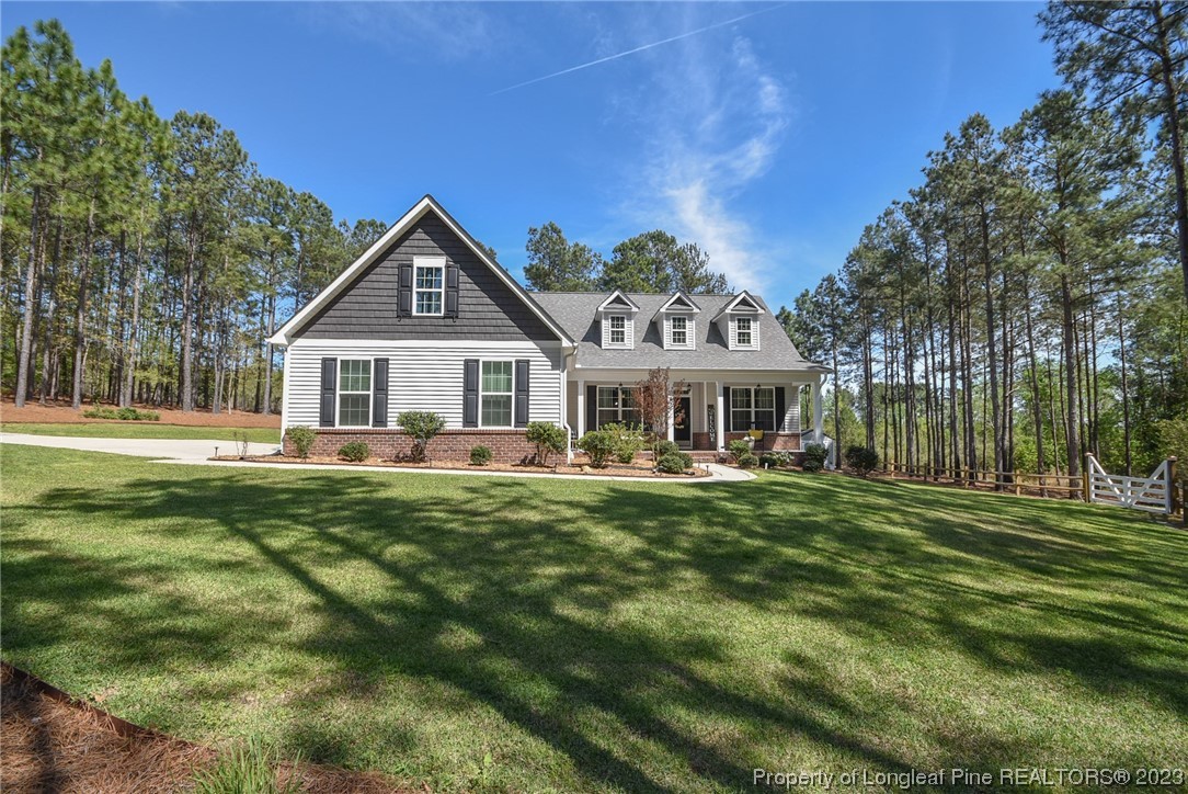 515 Bristling Pine Road Carthage, NC 28327 - Photo 3 of 40 a front view of a house with a garden