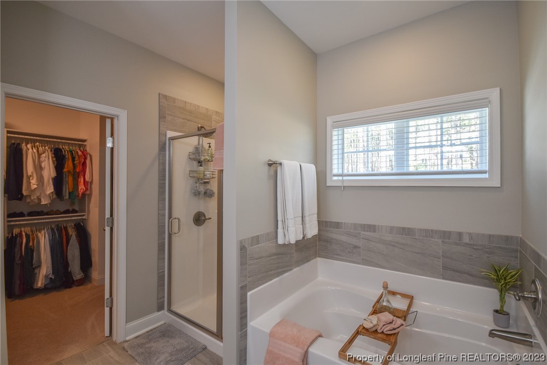 515 Bristling Pine Road Carthage, NC 28327 - Photo 31 of 40 a bathroom with a tub shower and window