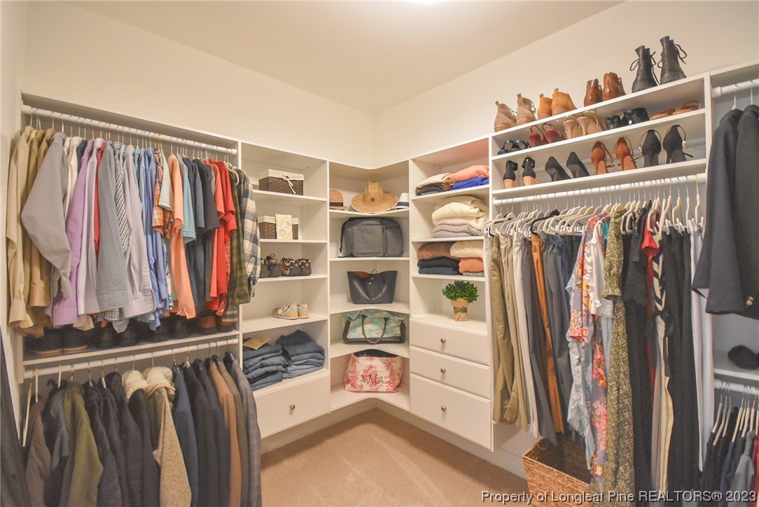 515 Bristling Pine Road Carthage, NC 28327 - Photo 32 of 40 a view of walk in closet with clothes and shoes