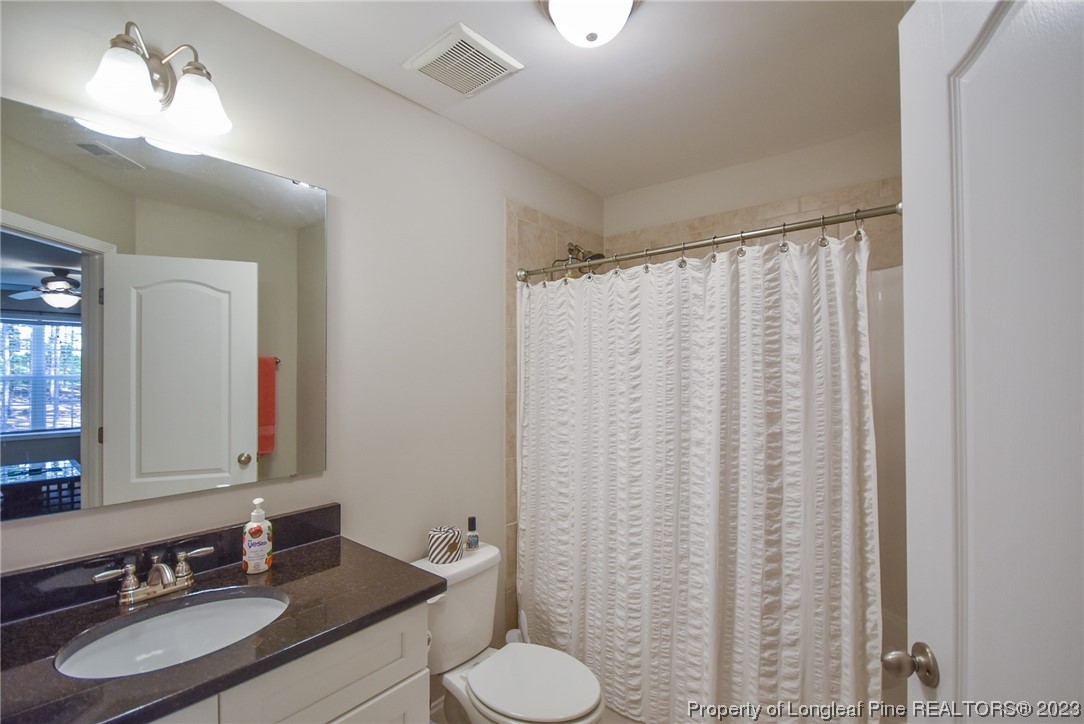 515 Bristling Pine Road Carthage, NC 28327 - Photo 40 of 40 a bathroom with a sink vanity mirror and toilet