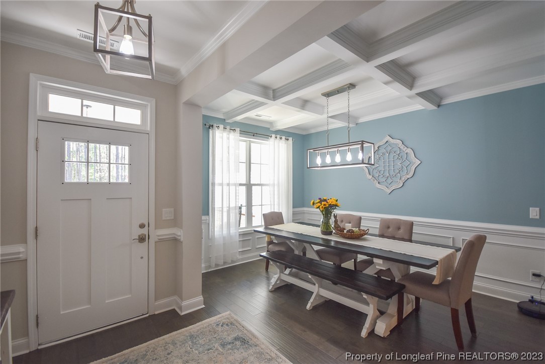 515 Bristling Pine Road Carthage, NC 28327 - Photo 9 of 40 a dining room with furniture a chandelier and wooden floor