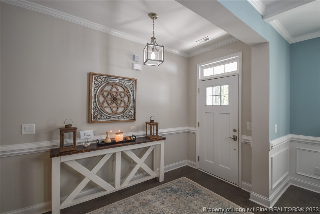 515 Bristling Pine Road Carthage, NC 28327 - Photo 10 of 40 a kitchen with stainless steel appliances granite countertop a sink dishwasher a refrigerator and white cabinets with wooden floor