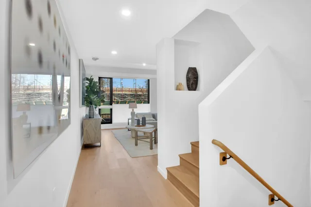 a bathroom with a double vanity sink a mirror and a bathtub