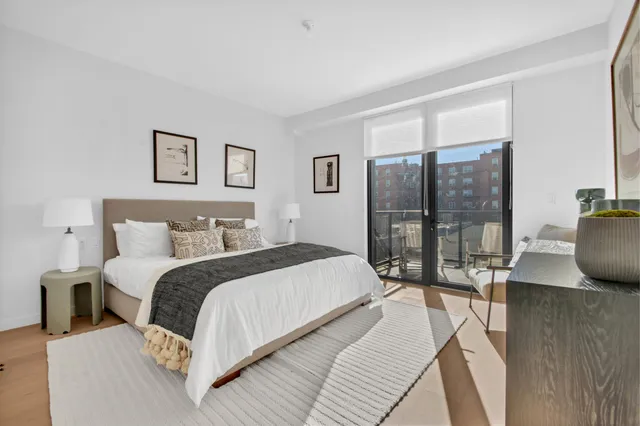 a bedroom with a bed and flat screen tv