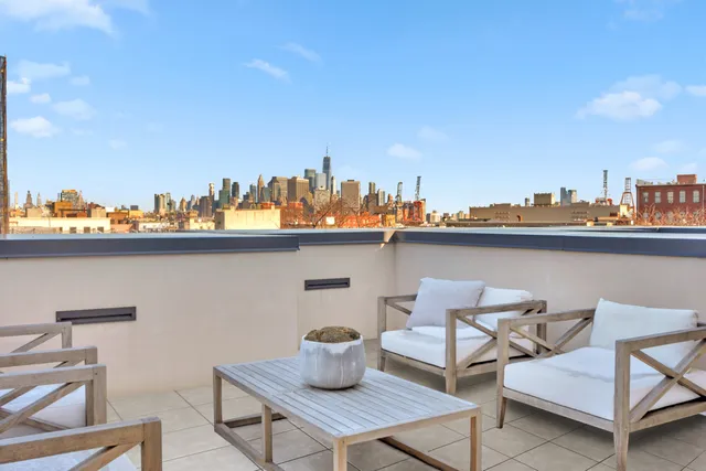 a front view of a building with large windows and a tree