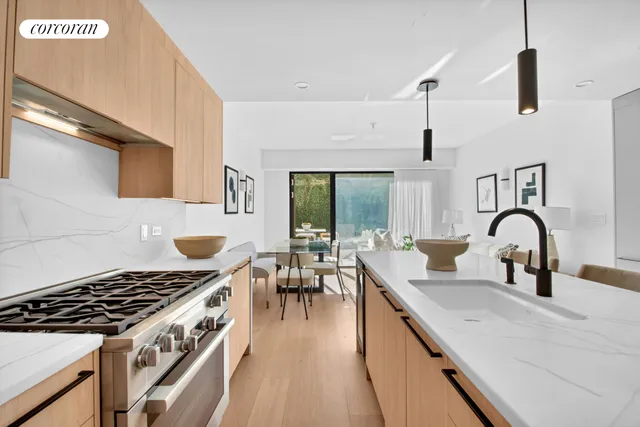 a kitchen with a table chairs sink and cabinets