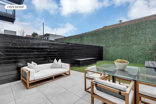 a view of a house with backyard and sitting area