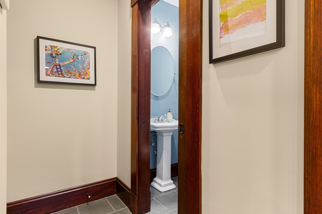 25 Bradford Street Needham, MA 02492 - Photo 17 of 38 a view of a hallway with paintings on the wall