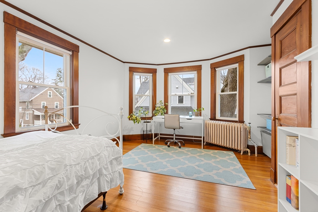25 Bradford Street Needham, MA 02492 - Photo 21 of 38 a bedroom with a bed and a large window with outer view