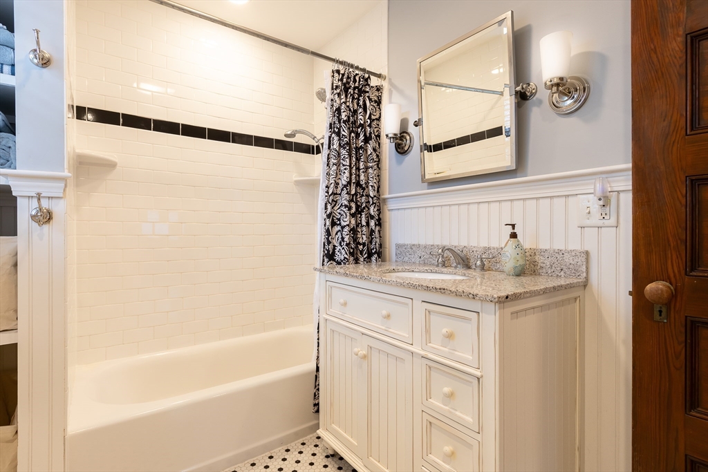 25 Bradford Street Needham, MA 02492 - Photo 23 of 38 a bathroom with a granite countertop sink a toilet and shower