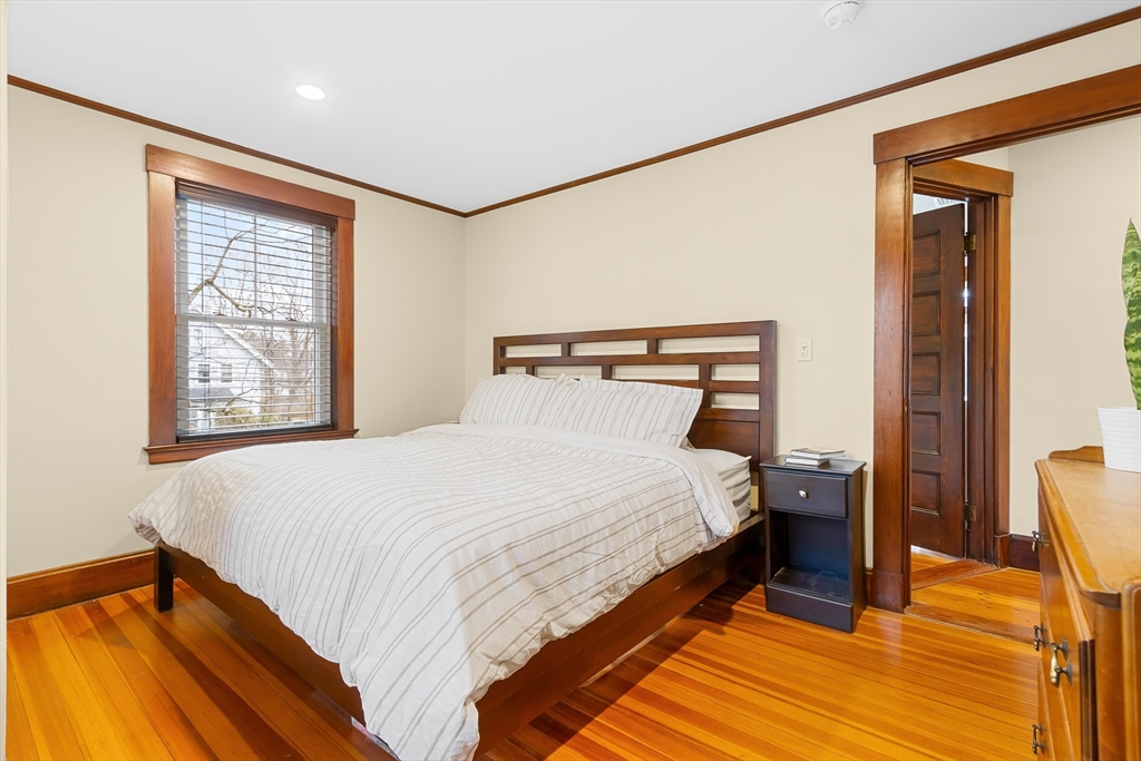 25 Bradford Street Needham, MA 02492 - Photo 24 of 38 a bedroom with a bed and wooden floor