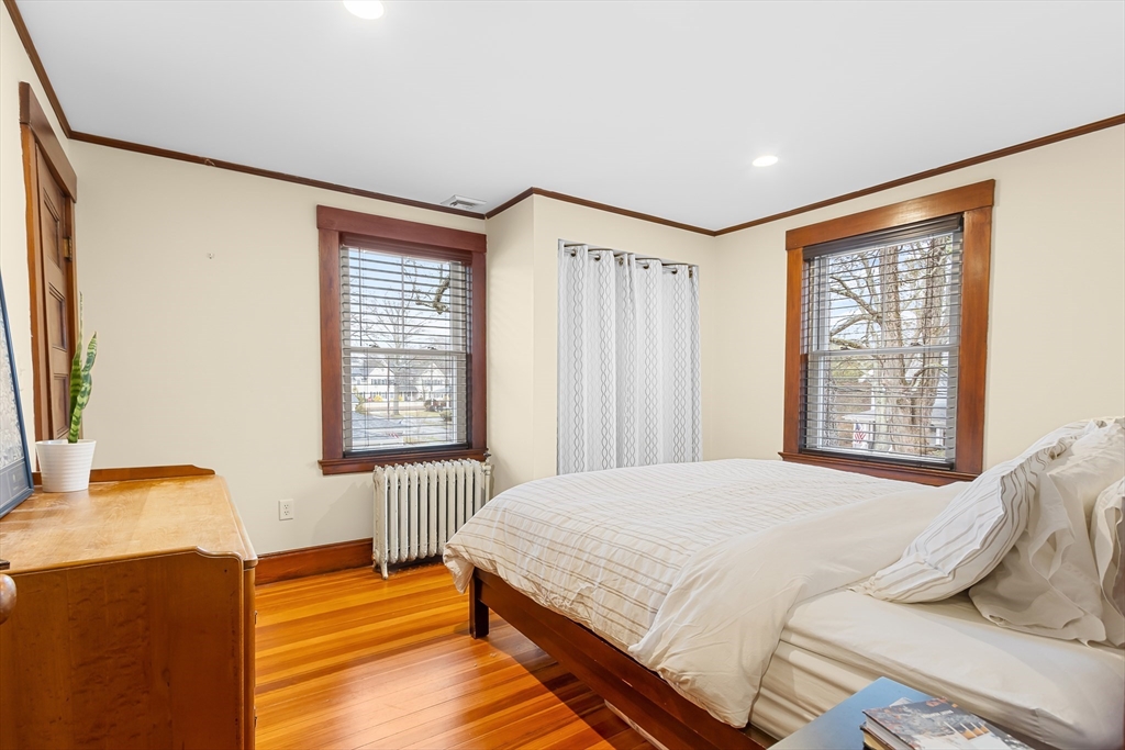 25 Bradford Street Needham, MA 02492 - Photo 25 of 38 a bedroom with a bed and wooden floor