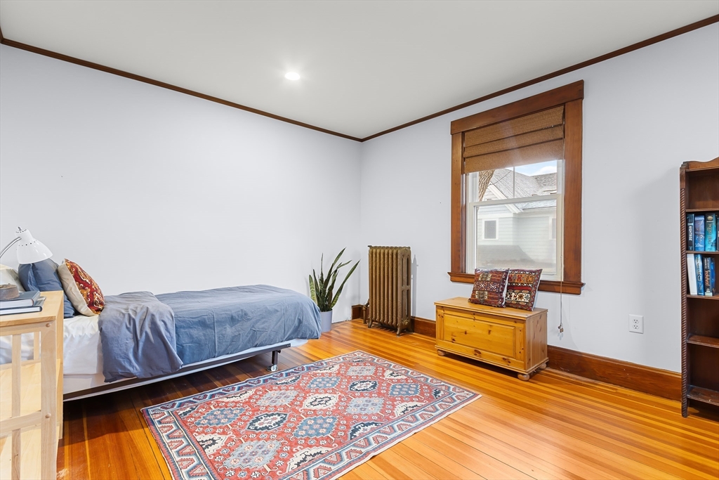 25 Bradford Street Needham, MA 02492 - Photo 26 of 38 a bedroom with furniture and a wooden floor