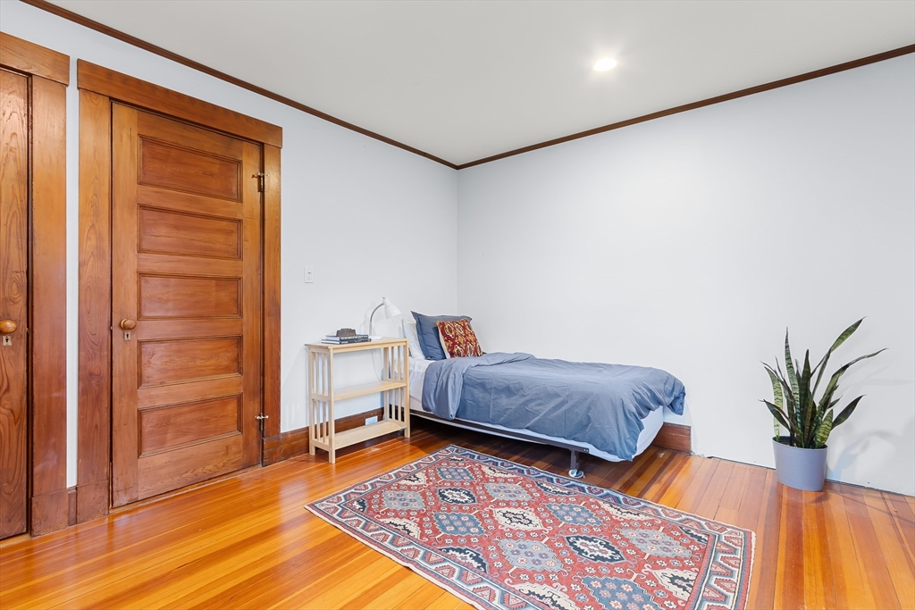 25 Bradford Street Needham, MA 02492 - Photo 27 of 38 a bedroom with furniture and a potted plant