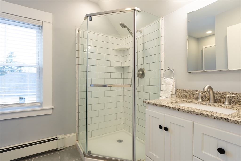 25 Bradford Street Needham, MA 02492 - Photo 30 of 38 a bathroom with a shower and a sink