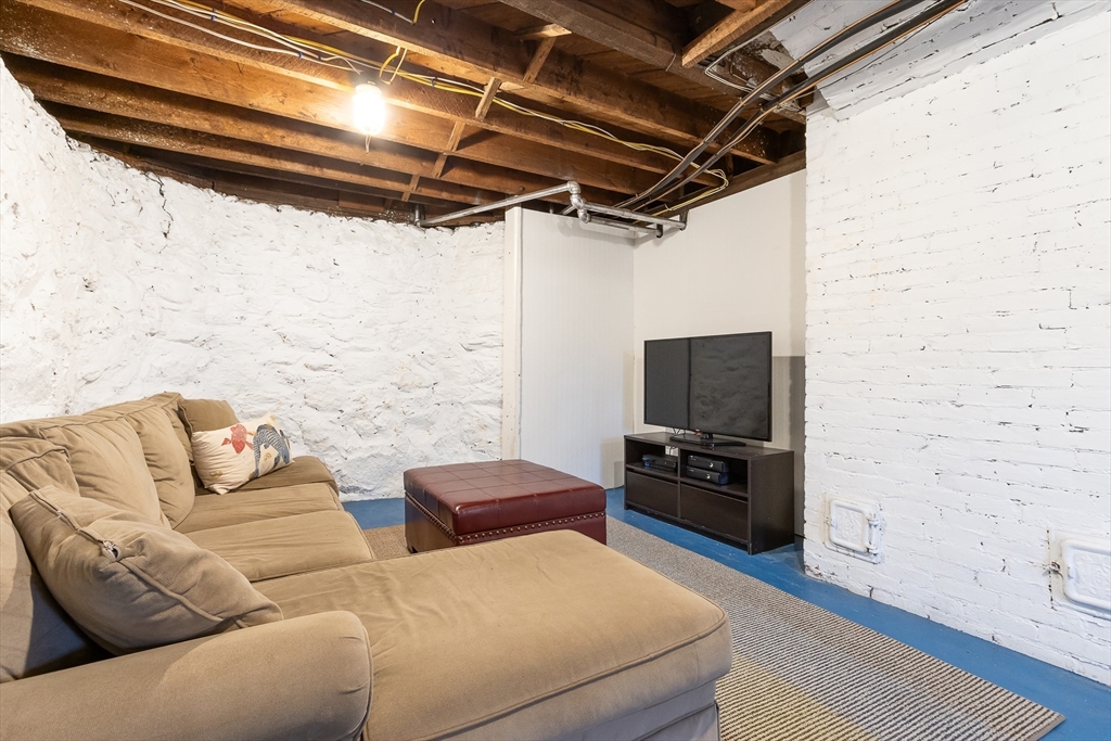 25 Bradford Street Needham, MA 02492 - Photo 33 of 38 a living room with furniture and a flat screen tv