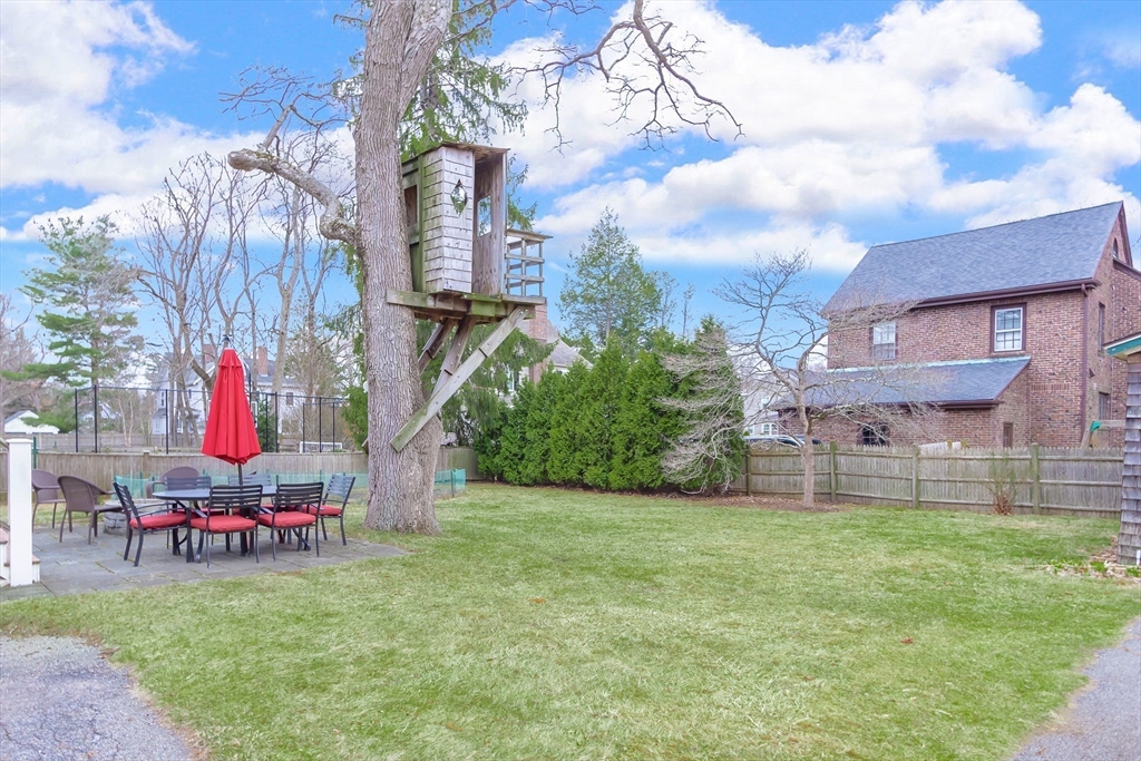 25 Bradford Street Needham, MA 02492 - Photo 35 of 38 a backyard of a house with table and chairs