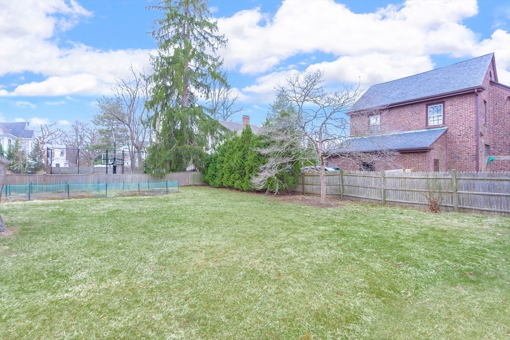 25 Bradford Street Needham, MA 02492 - Photo 36 of 38 a backyard of a house with lots of green space