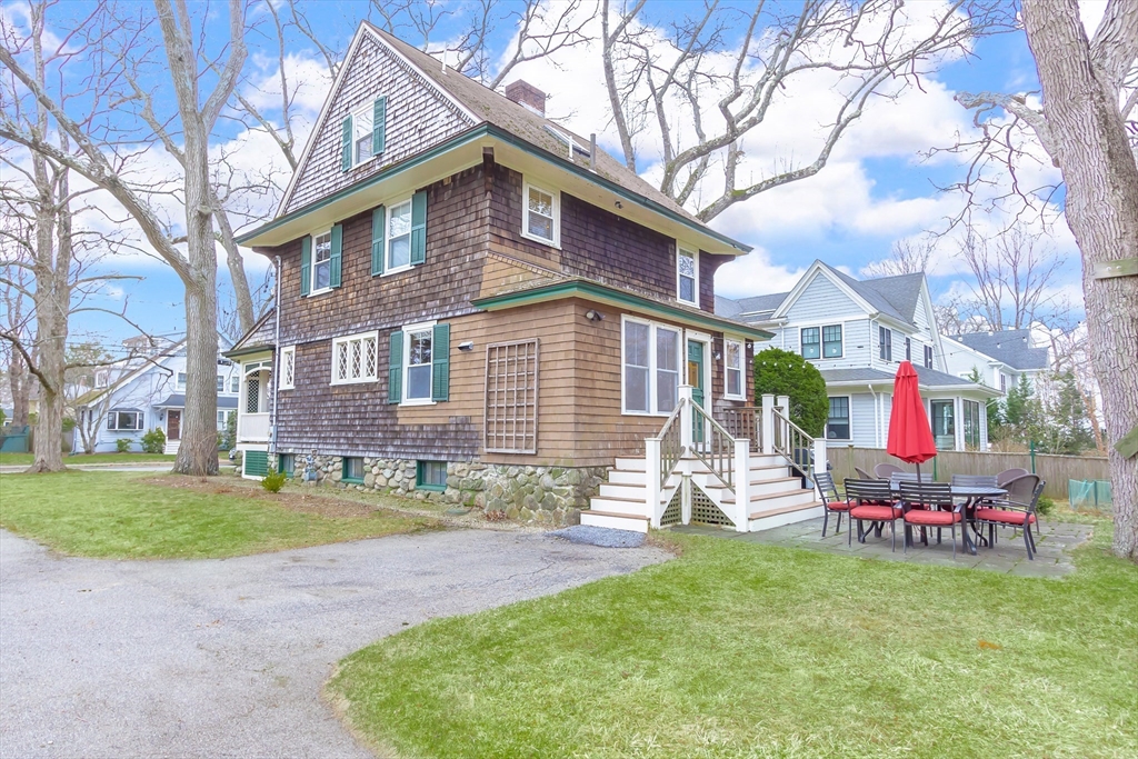 25 Bradford Street Needham, MA 02492 - Photo 38 of 38 a front view of a house with a yard and garage