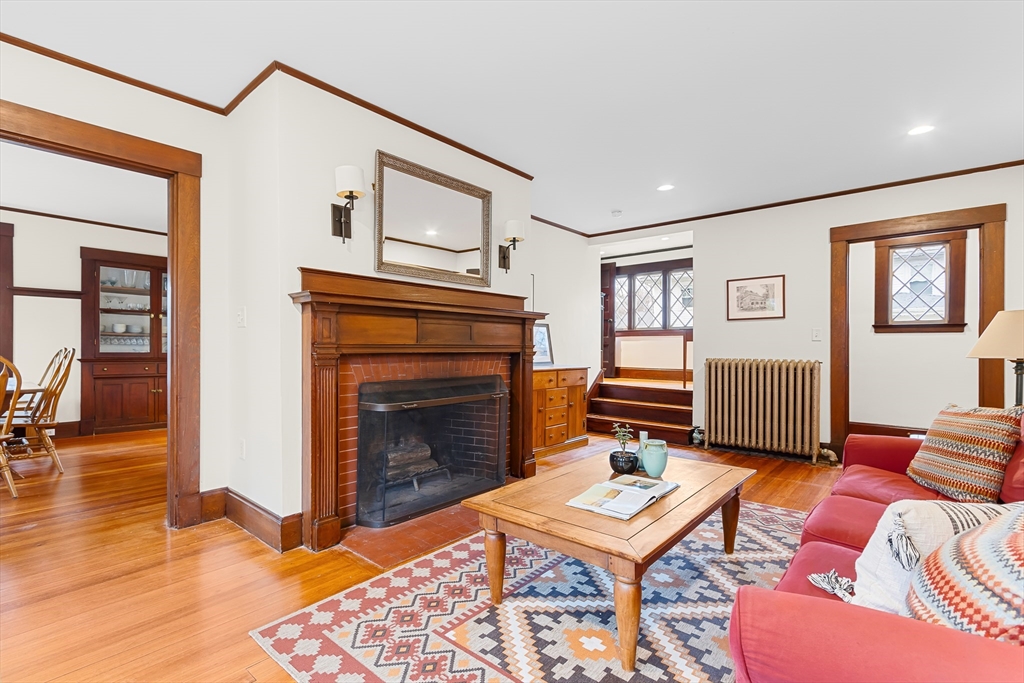 25 Bradford Street Needham, MA 02492 - Photo 8 of 38 a living room with furniture a rug and a fireplace
