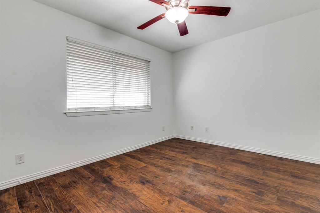 5508 Tremont Street, Unit 8 Dallas, TX 75214 - Photo 11 of 12 Empty room with dark wood-style flooring and ceiling fan