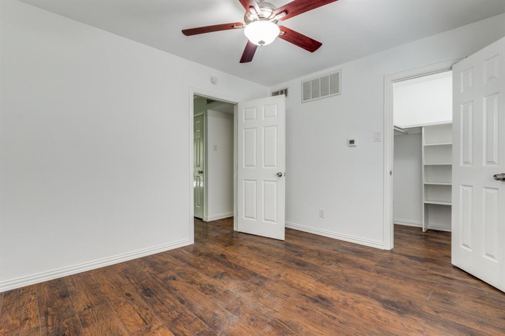5508 Tremont Street, Unit 8 Dallas, TX 75214 - Photo 12 of 12 Unfurnished bedroom with a walk in closet, dark wood-style flooring, and a ceiling fan