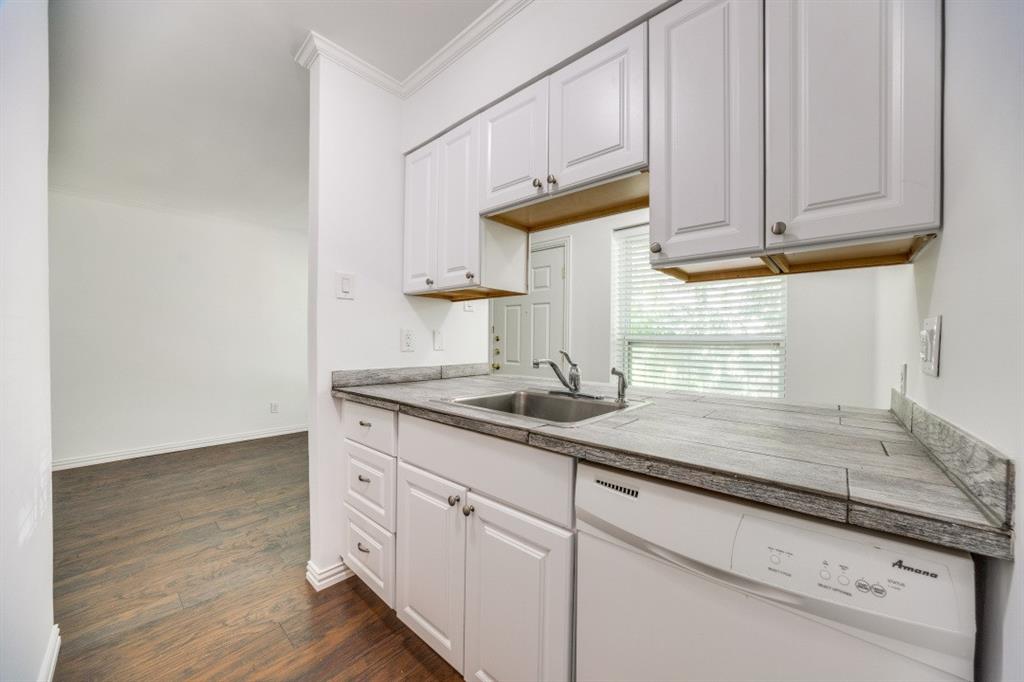 5508 Tremont Street, Unit 8 Dallas, TX 75214 - Photo 8 of 12 Kitchen with dishwasher, dark wood-style flooring, white cabinets, and ornamental molding