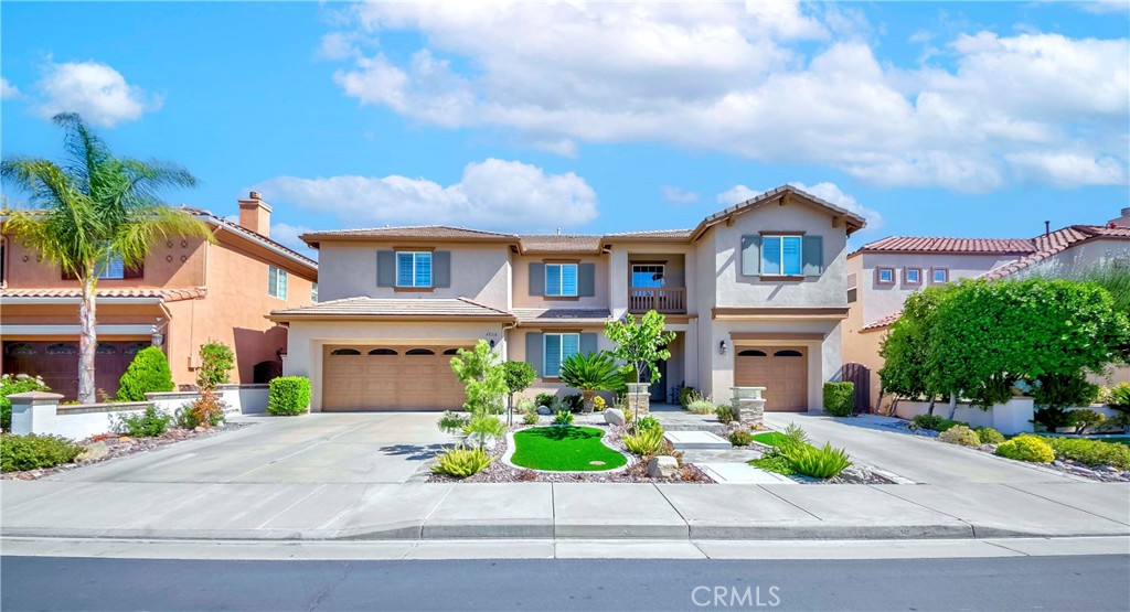 45316 St Tisbury Street Temecula, CA 92592 - Photo 2 of 62 a front view of a house with a garden and potted plants